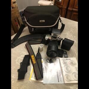 NIKON N65 CAMERA WITH PROMASTER LONG LEN INCLUDED AND MORE INCLUDED.